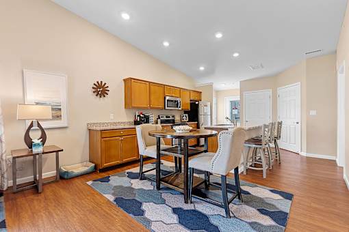 A modern kitchen with a dining table and chairs.