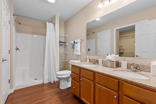 A bathroom with a toilet, sink, and shower.