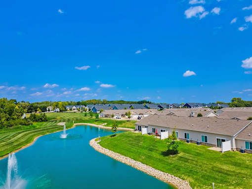 A beautiful residential area with a lake and a fountain.