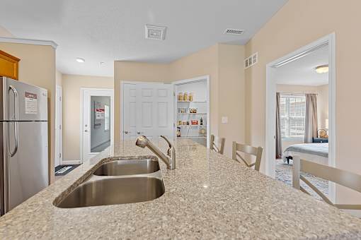 A kitchen with granite countertops and stainless steel appliances.