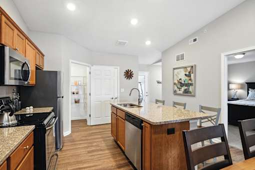 A kitchen with wooden cabinets and a granite countertop.