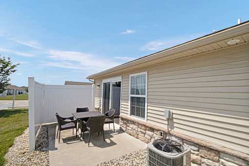 A house with a patio table and chairs.