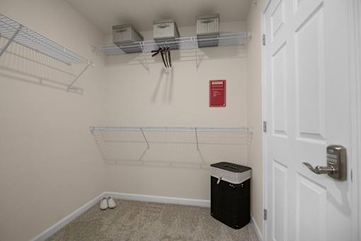A white closet with a red sign on the wall.