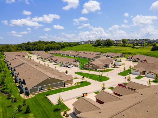 A suburban neighborhood with houses and green lawns.