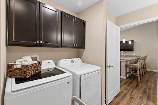 A kitchen with a white dishwasher and a white oven.