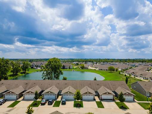 A suburban neighborhood with houses and a lake.