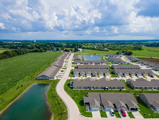 A bird's eye view of a residential area with houses and a river.