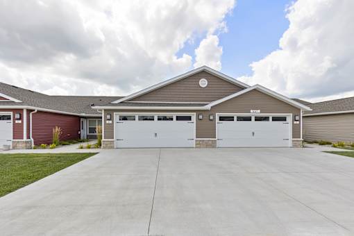 A two-car garage with a brown roof and white doors.