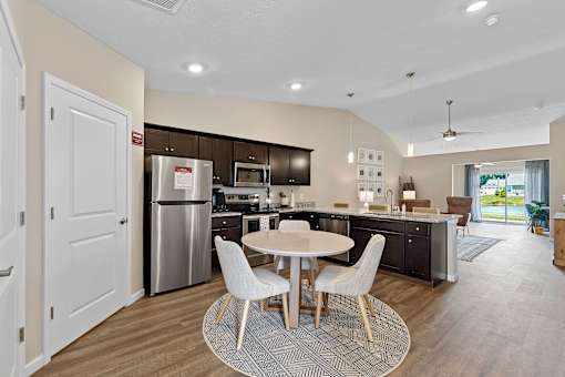 A modern kitchen with a dining table and chairs.