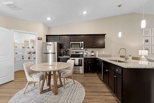 A modern kitchen with a table and chairs.