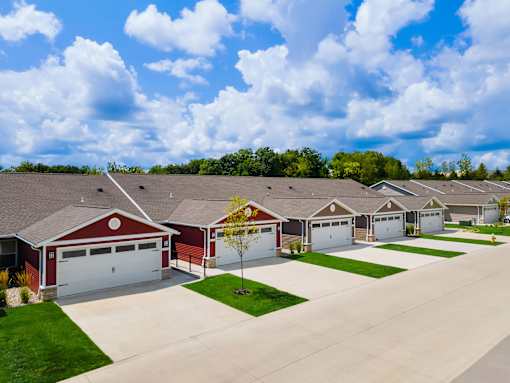 A row of houses with garages and driveways.