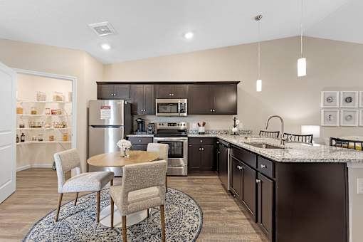 A modern kitchen with a dining table and chairs.