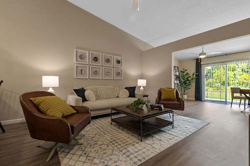 A living room with a brown chair and a white couch.