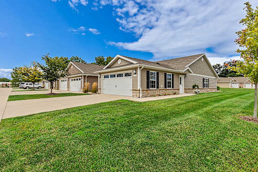 A house with a garage and a driveway in front.