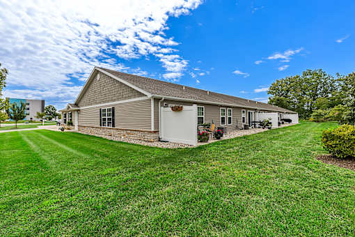 A house with a grey roof and a white garage door.
