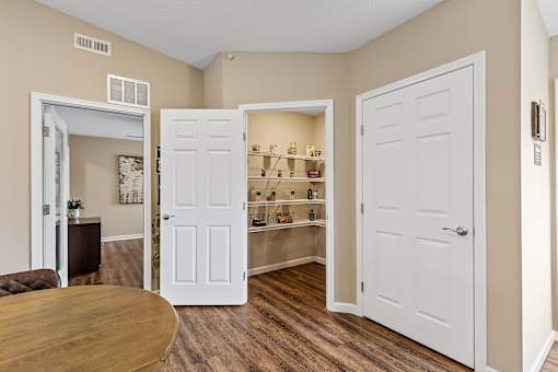 A room with a brown table and a white door.
