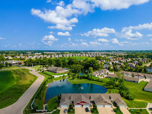 A suburban neighborhood with a pond and houses.