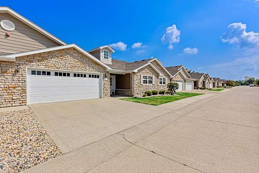 A row of houses with a clear blue sky above them.