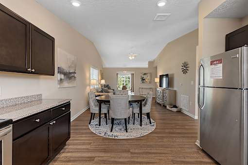 A kitchen with a table and chairs in the middle of the room.