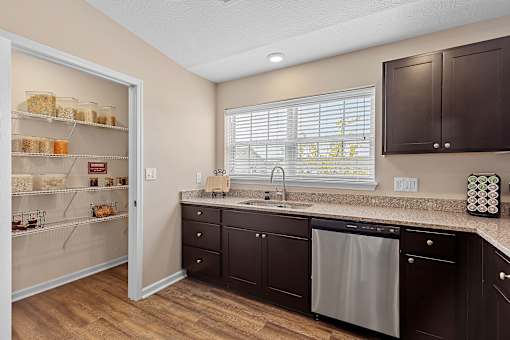 A kitchen with brown cabinets and a white fridge.
