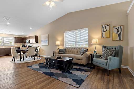 A living room with a grey couch and a coffee table.