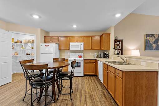 A kitchen with wooden cabinets and a white fridge.