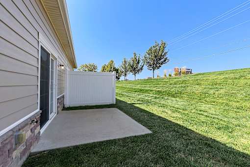 A house with a white fence and a green lawn.