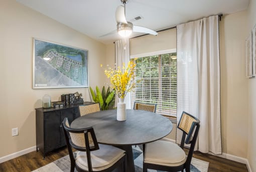 a dining room with a table and chairs and a window