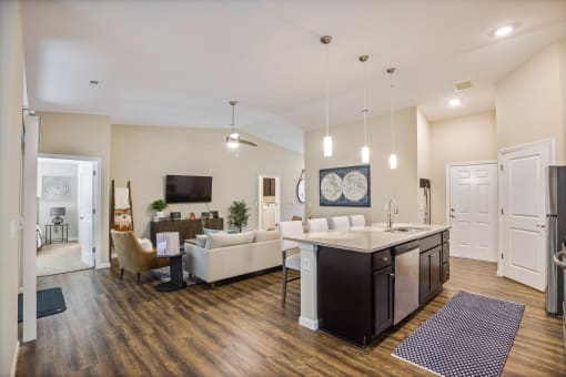 a living room with a kitchen and a dining room