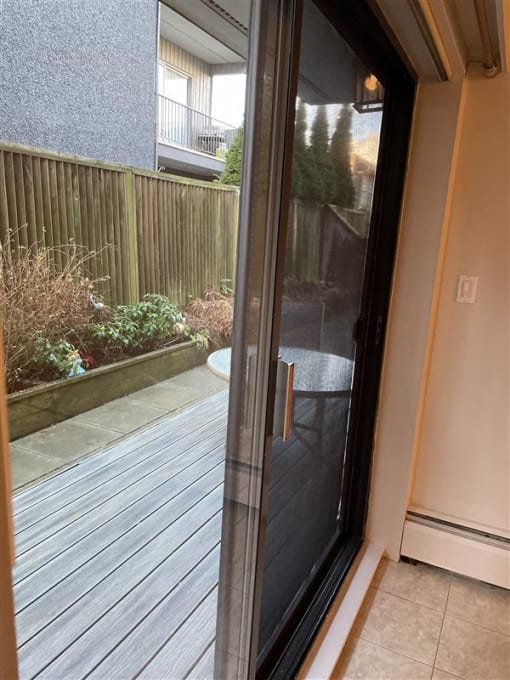 a sliding glass door with a view of a patio