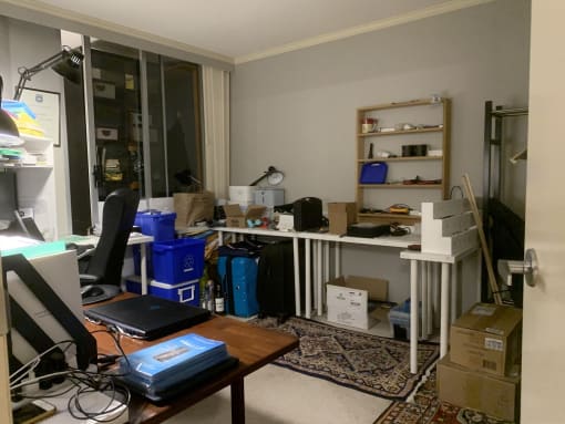 a cluttered office with a desk and a computer