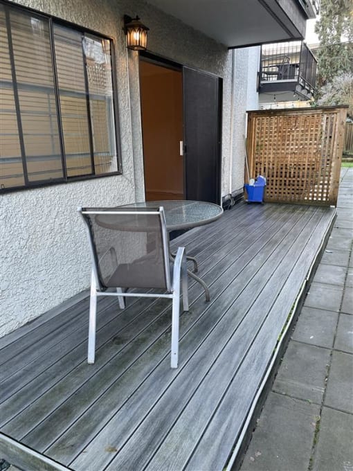 a patio with a chair and a table on it