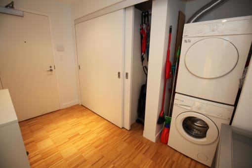 a bedroom in a shared house with a washer and dryer