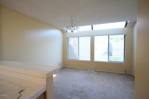 a bedroom with a large window and a white counter