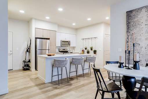 an open kitchen and dining area with a table and chairs