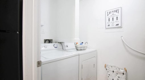 a small laundry room with a sink and a washing machine