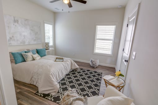 a bedroom with a bed and a ceiling fan