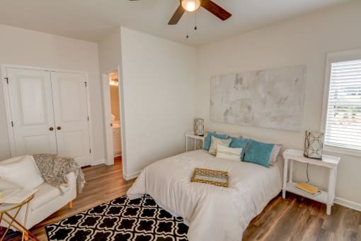 a bedroom with a bed and a ceiling fan