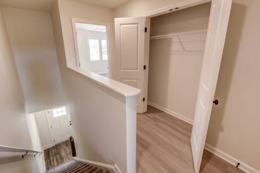 a bedroom with a medium sized bed and a closet with a mirrored door