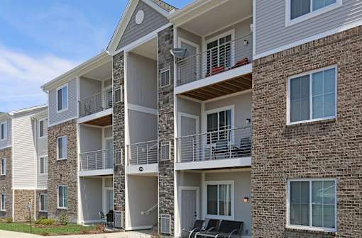Apartment building with balconies and windows.