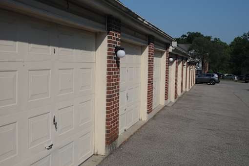 A row of white garage doors are closed.