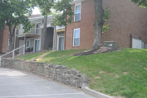 A brick building with a tree in front of it.