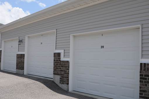 Three white garage doors are closed and numbered 38 and 39.