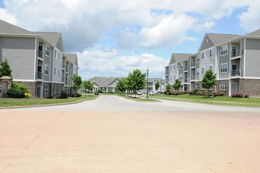 A street view of a residential area with apartment buildings on both sides.