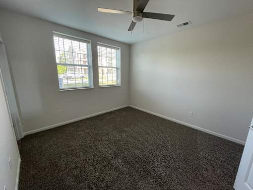 A room with a ceiling fan and carpeted floor at Hamlet On The Bend, Hebrun, KY, 41048