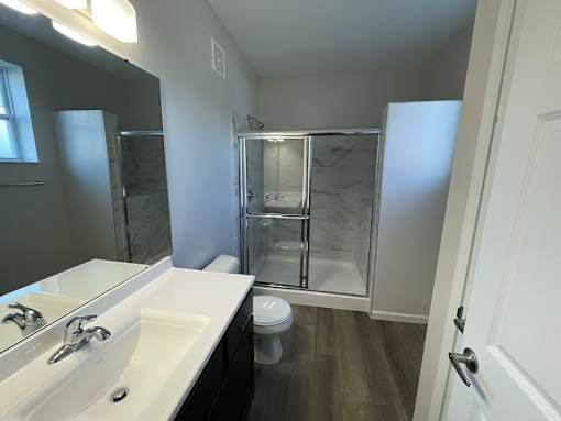 A bathroom with a white sink and a walk-in shower at Hamlet On The Bend, Hebrun, 41048