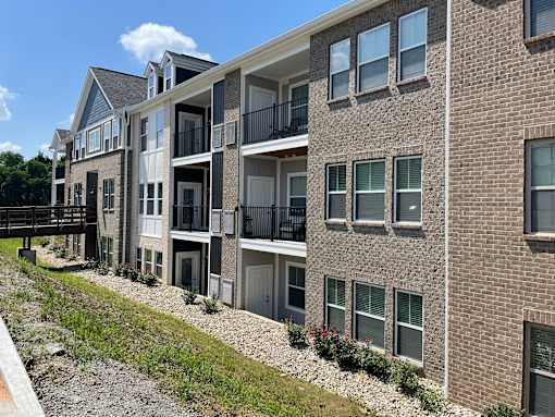 A multi-story apartment building with balconies and windows at Hamlet On The Bend, Hebrun, KY, 41048