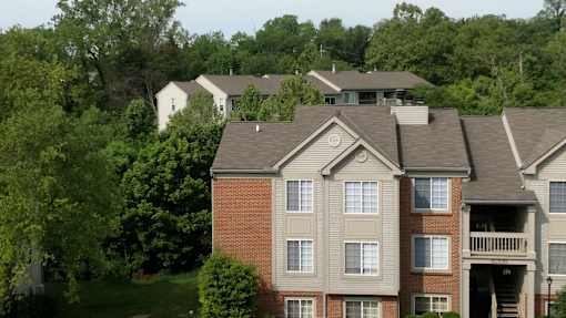 A large apartment building with a balcony on the second floor.