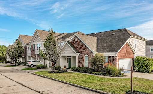 A row of houses with a car parked in front of the first one at Twin Fountains Apartments, Mason, OH, 45040