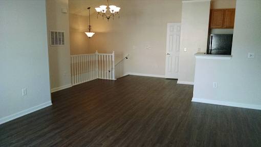 A room with wooden floors and a white door at Twin Fountains Apartments, Mason, 45040